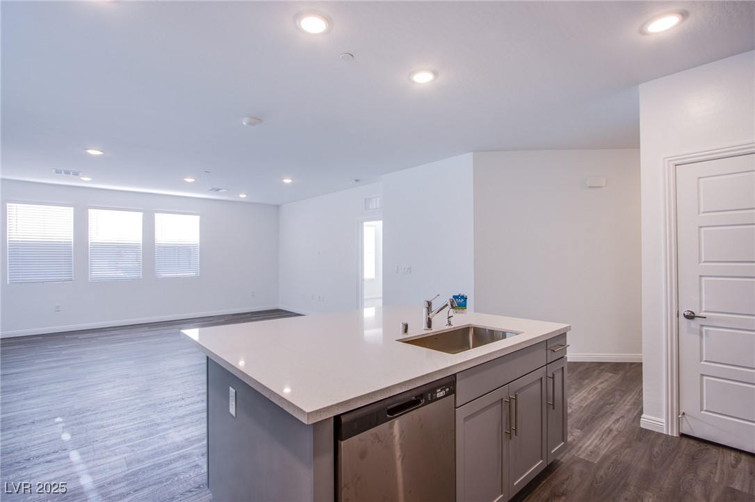 2555 Hampton Road, Unit 4109 Henderson, NV 89052 - Photo 7 of 38 Kitchen featuring dishwasher, light countertops, dark wood-type flooring, a kitchen island with sink, and recessed lighting