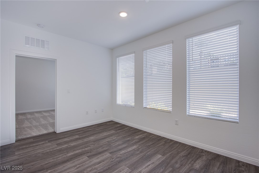 2555 Hampton Road, Unit 4109 Henderson, NV 89052 - Photo 9 of 38 Empty room featuring dark wood-style floors and recessed lighting