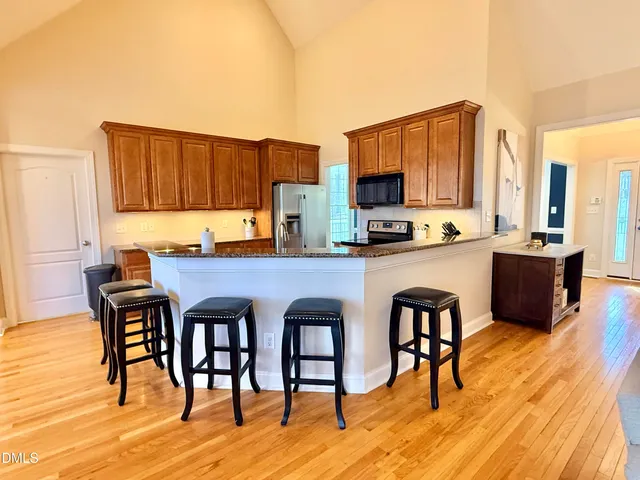 a large kitchen with a large window and stainless steel appliances