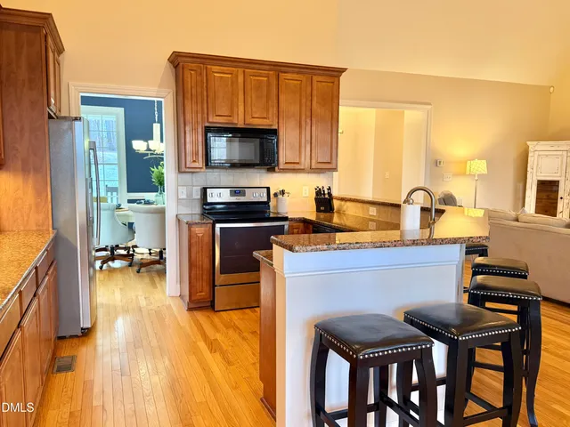 a dining room with furniture a chandelier and wooden floor