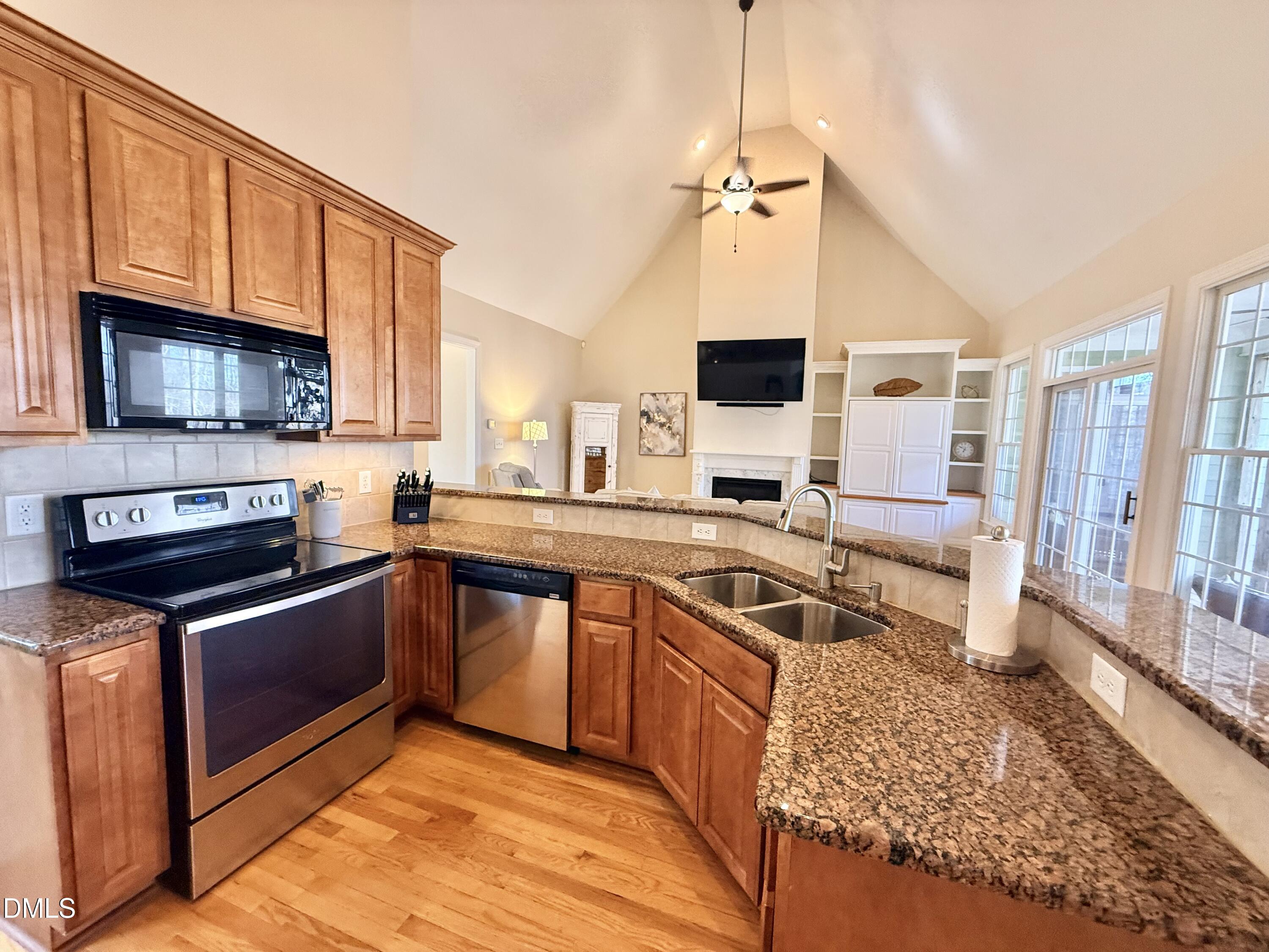 199 Oakwood Lane Roxboro, NC 27574 - Photo 17 of 82 a kitchen with stainless steel appliances granite countertop a sink stove and microwave