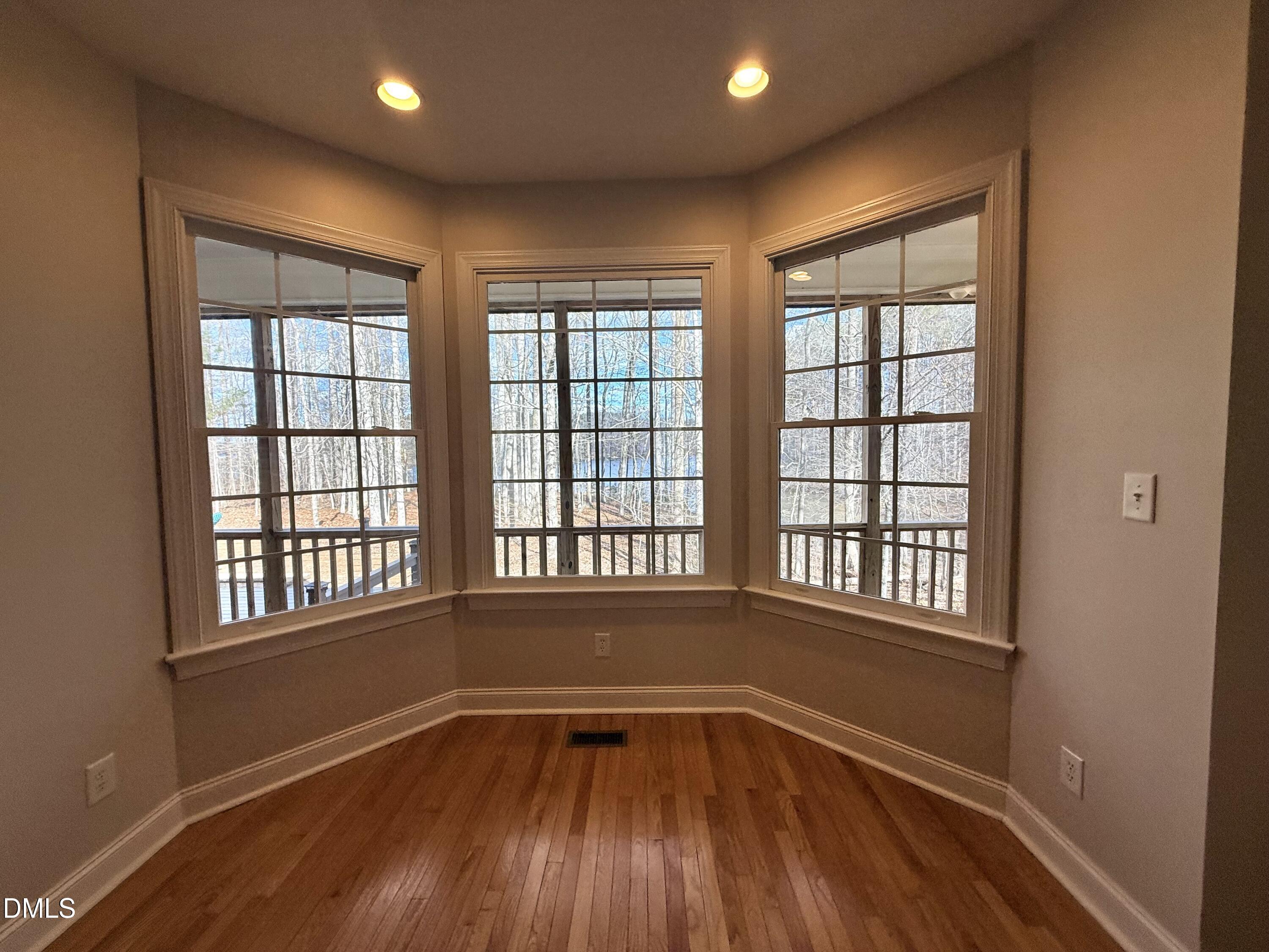 199 Oakwood Lane Roxboro, NC 27574 - Photo 20 of 82 an empty room with wooden floor and windows