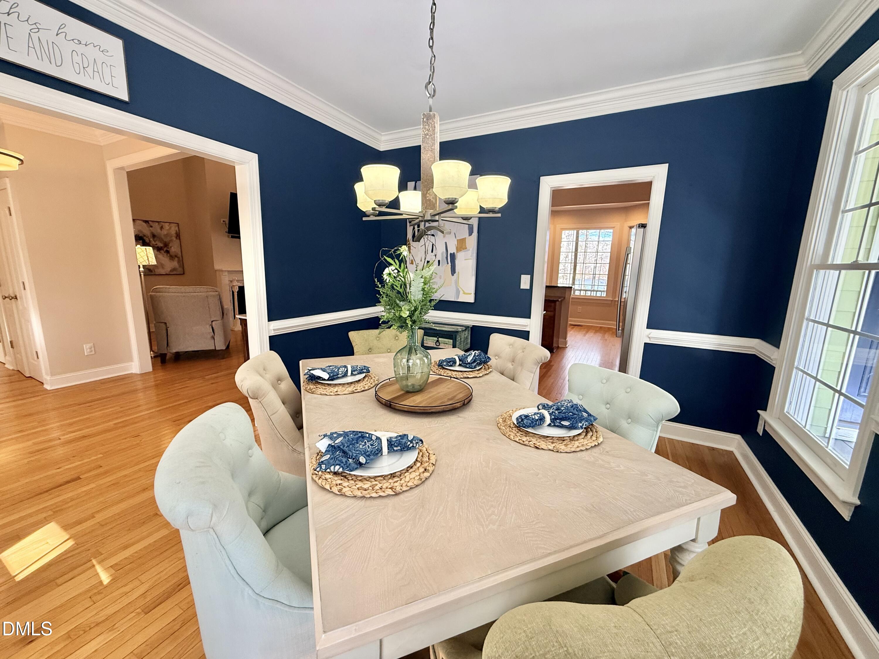 199 Oakwood Lane Roxboro, NC 27574 - Photo 23 of 82 a dining room with furniture a chandelier and wooden floor