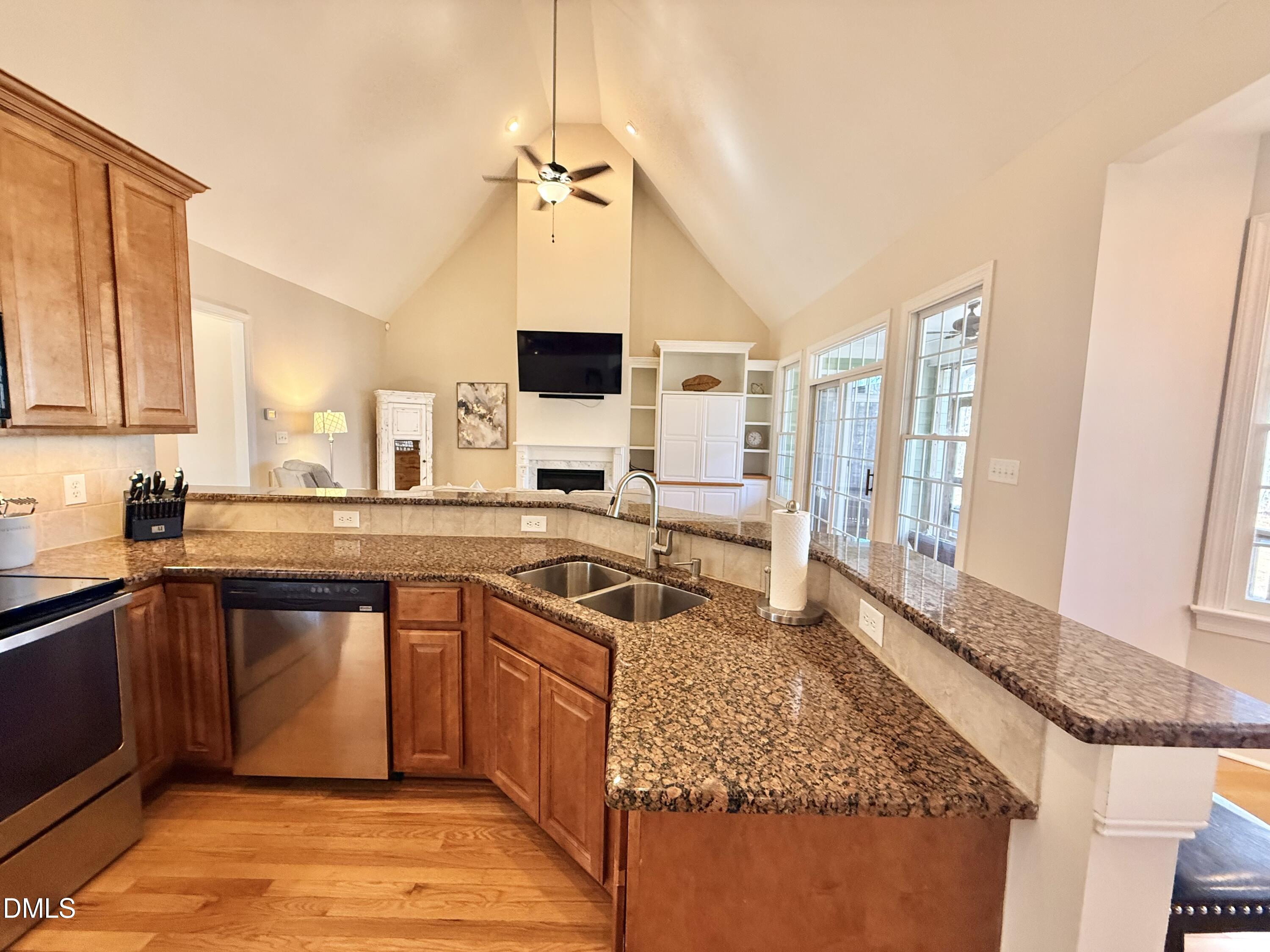 199 Oakwood Lane Roxboro, NC 27574 - Photo 25 of 82 a kitchen with stainless steel appliances granite countertop a sink stove and refrigerator