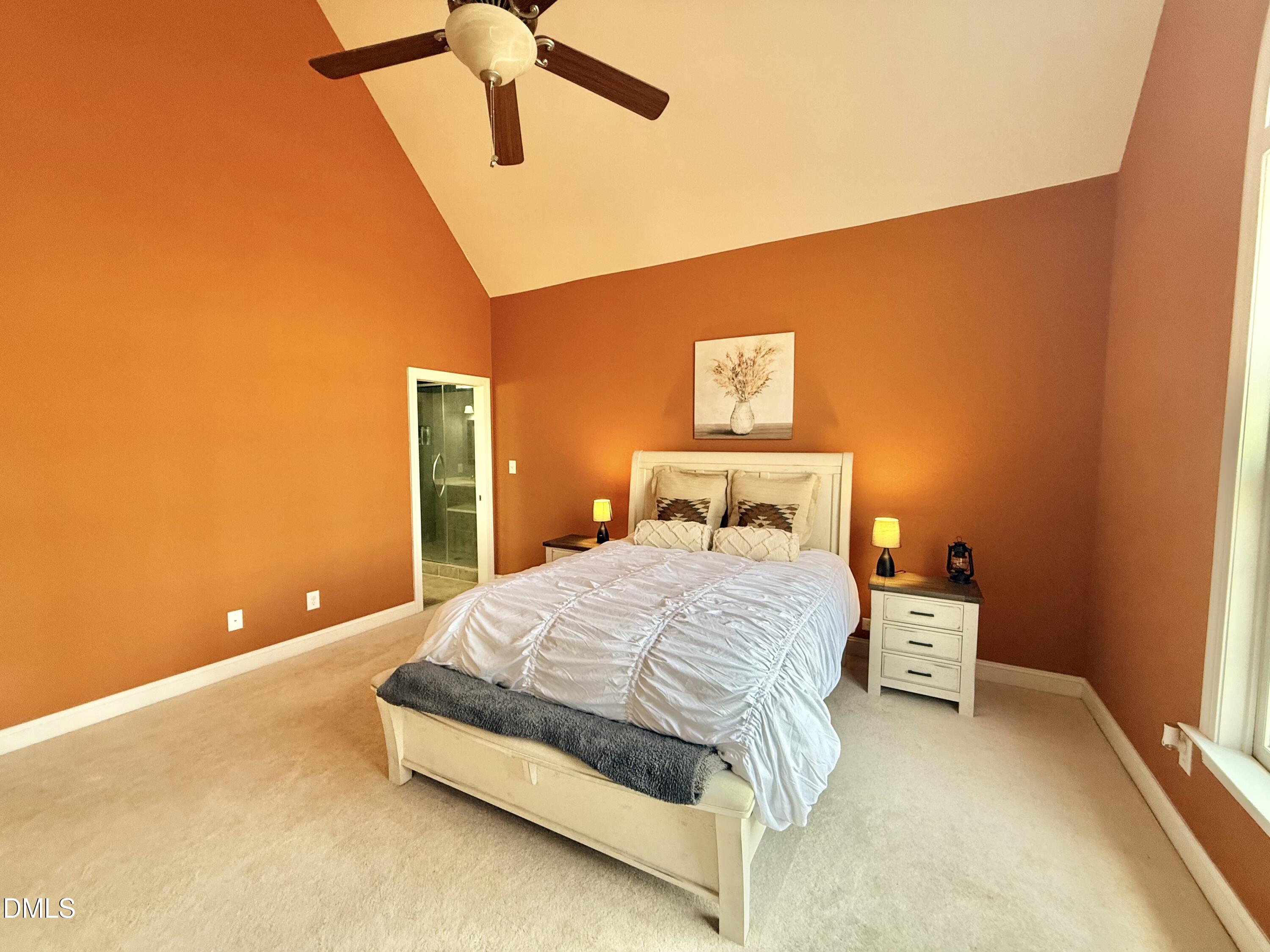 199 Oakwood Lane Roxboro, NC 27574 - Photo 28 of 82 a bedroom with a bed and lamp with window