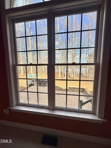 a bed room with a bed mirror and a window
