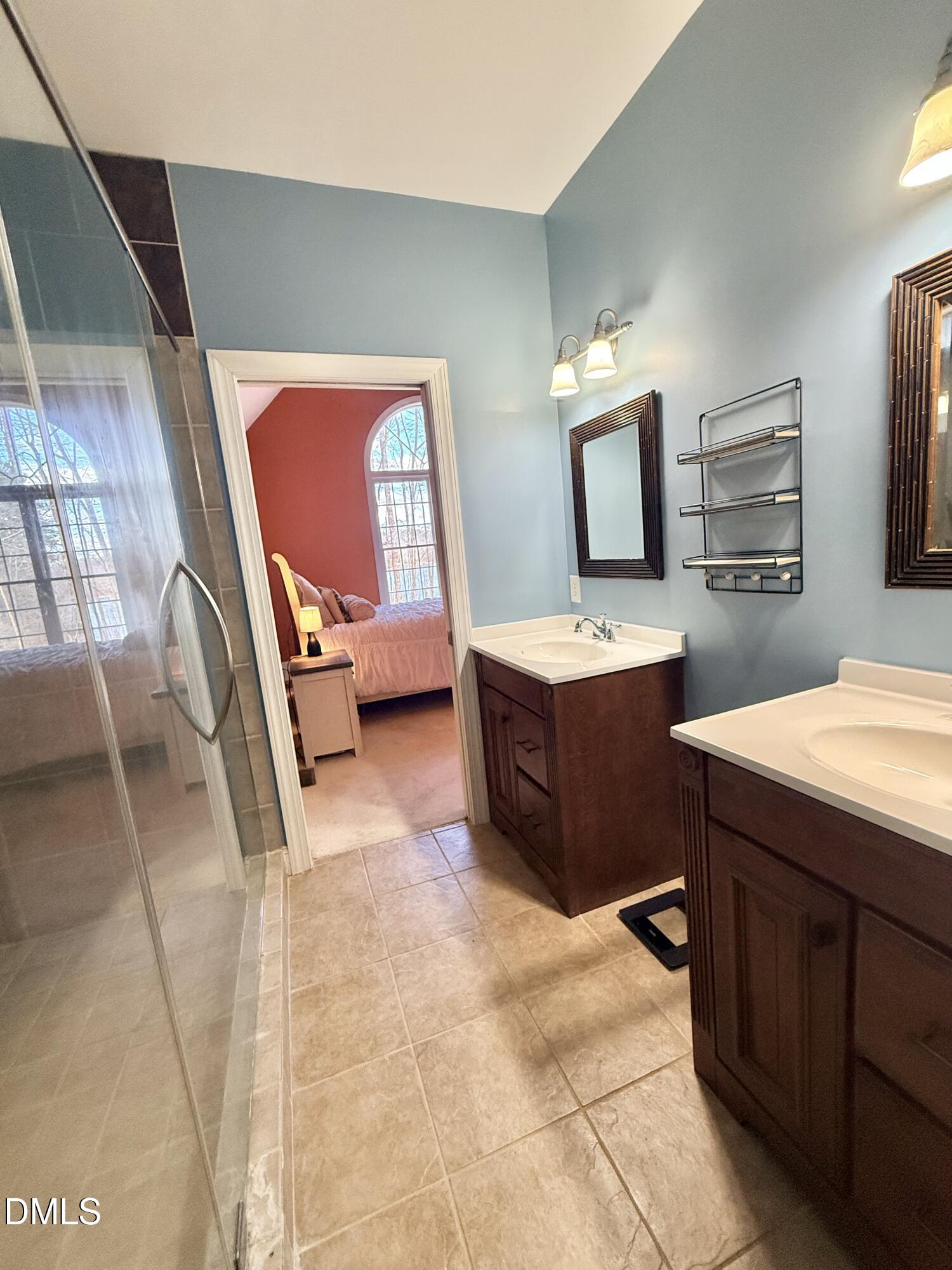 199 Oakwood Lane Roxboro, NC 27574 - Photo 42 of 82 a en suite bathroom with a sink vanity and mirror