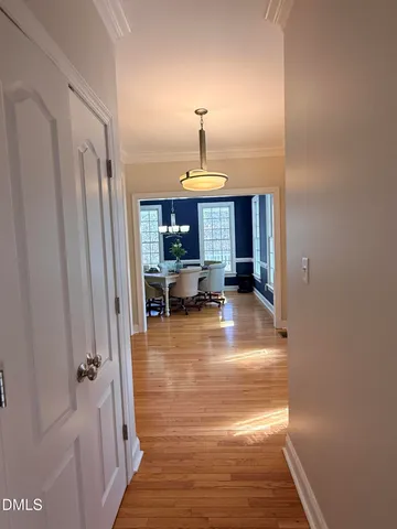 a view of a living room with wooden floor and windows