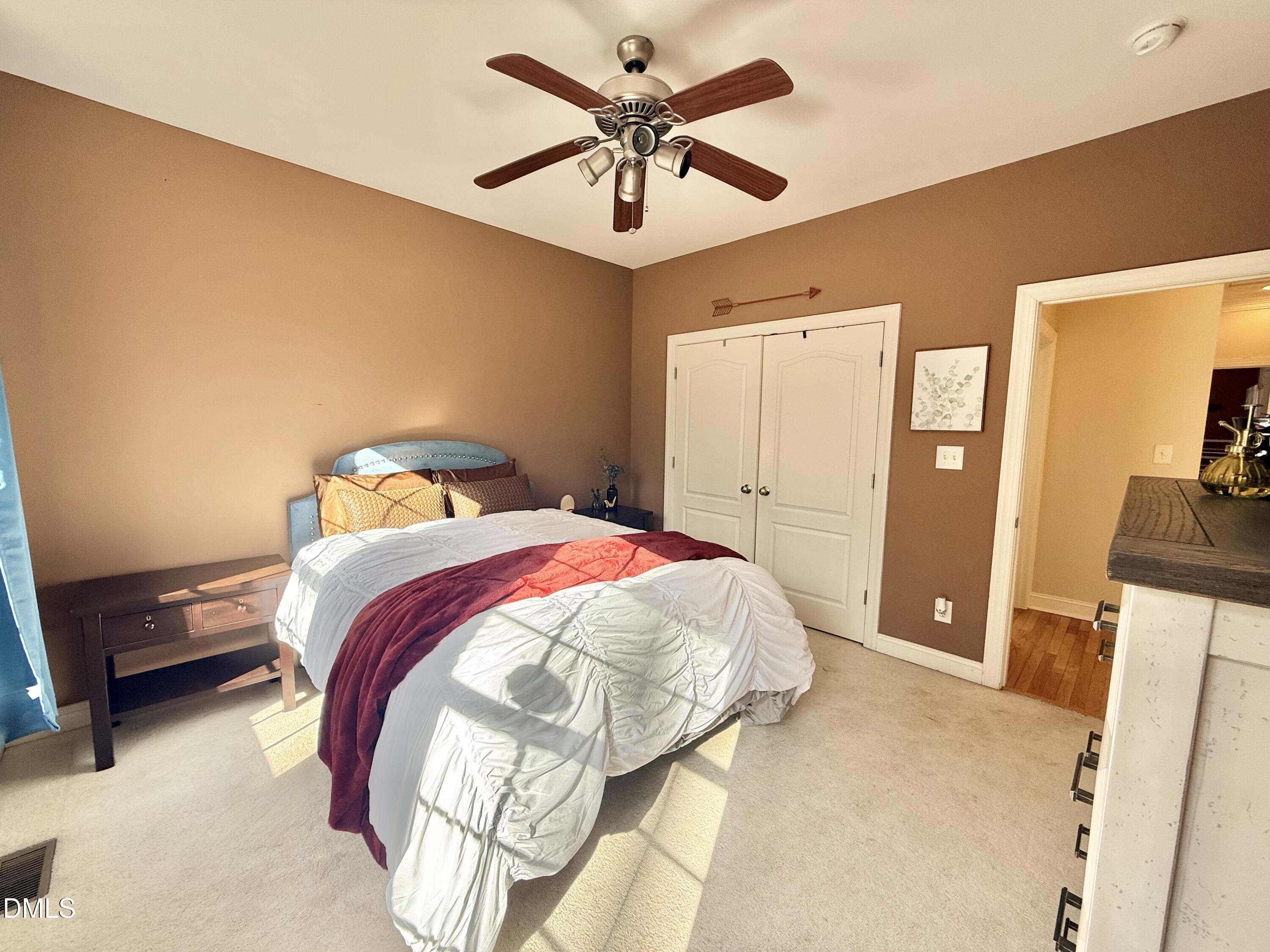 199 Oakwood Lane Roxboro, NC 27574 - Photo 44 of 82 a bedroom with a bed and a chandelier