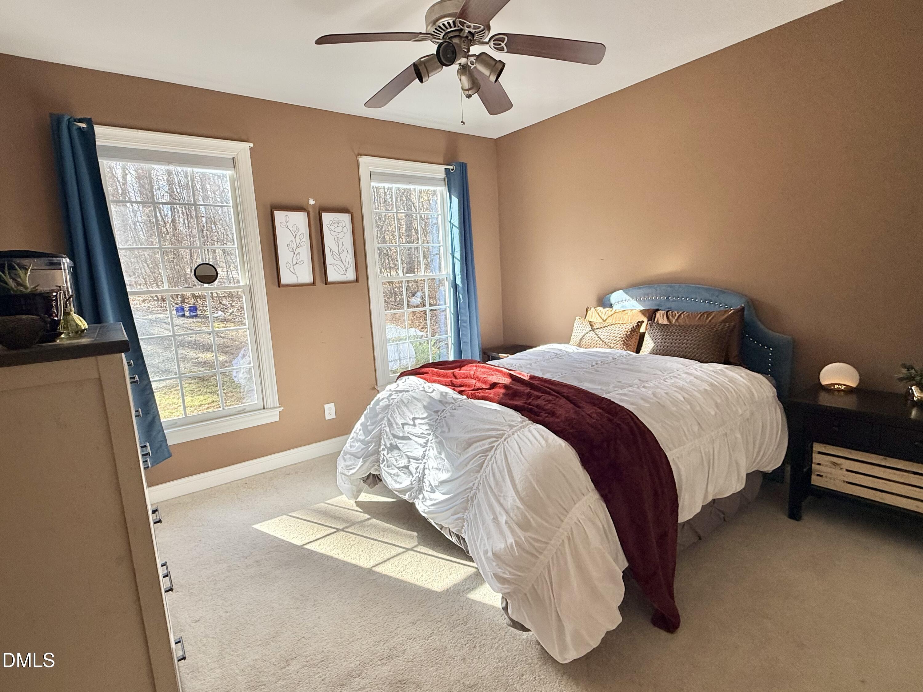199 Oakwood Lane Roxboro, NC 27574 - Photo 47 of 82 a bed sitting in a bedroom next to a window