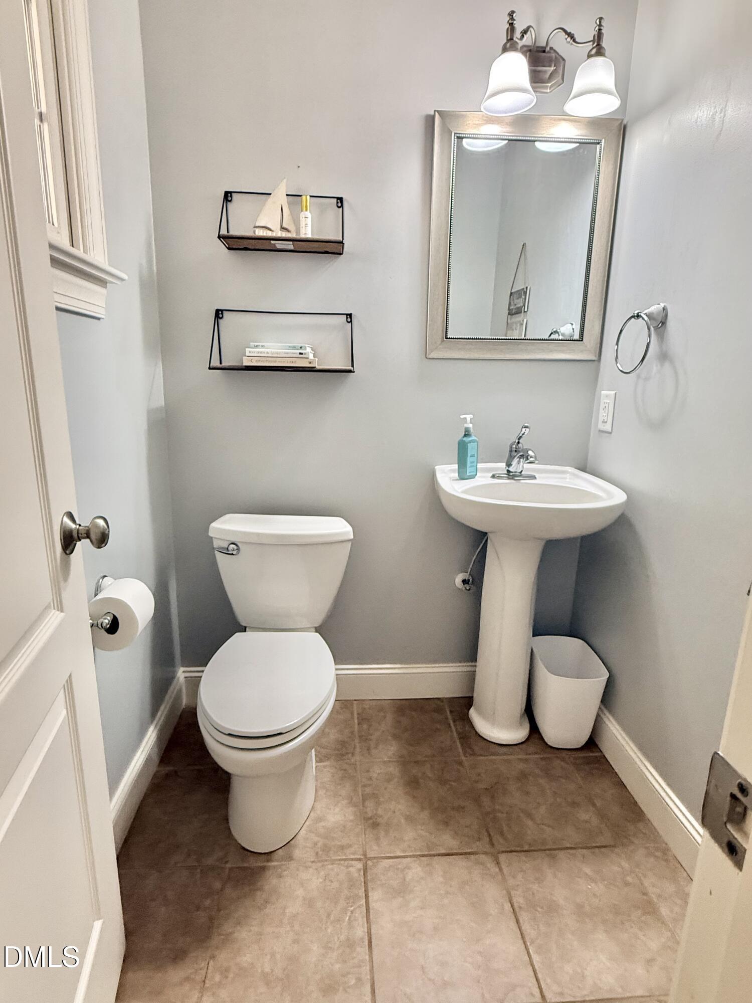 199 Oakwood Lane Roxboro, NC 27574 - Photo 52 of 82 a white toilet sitting next to a bathroom sink