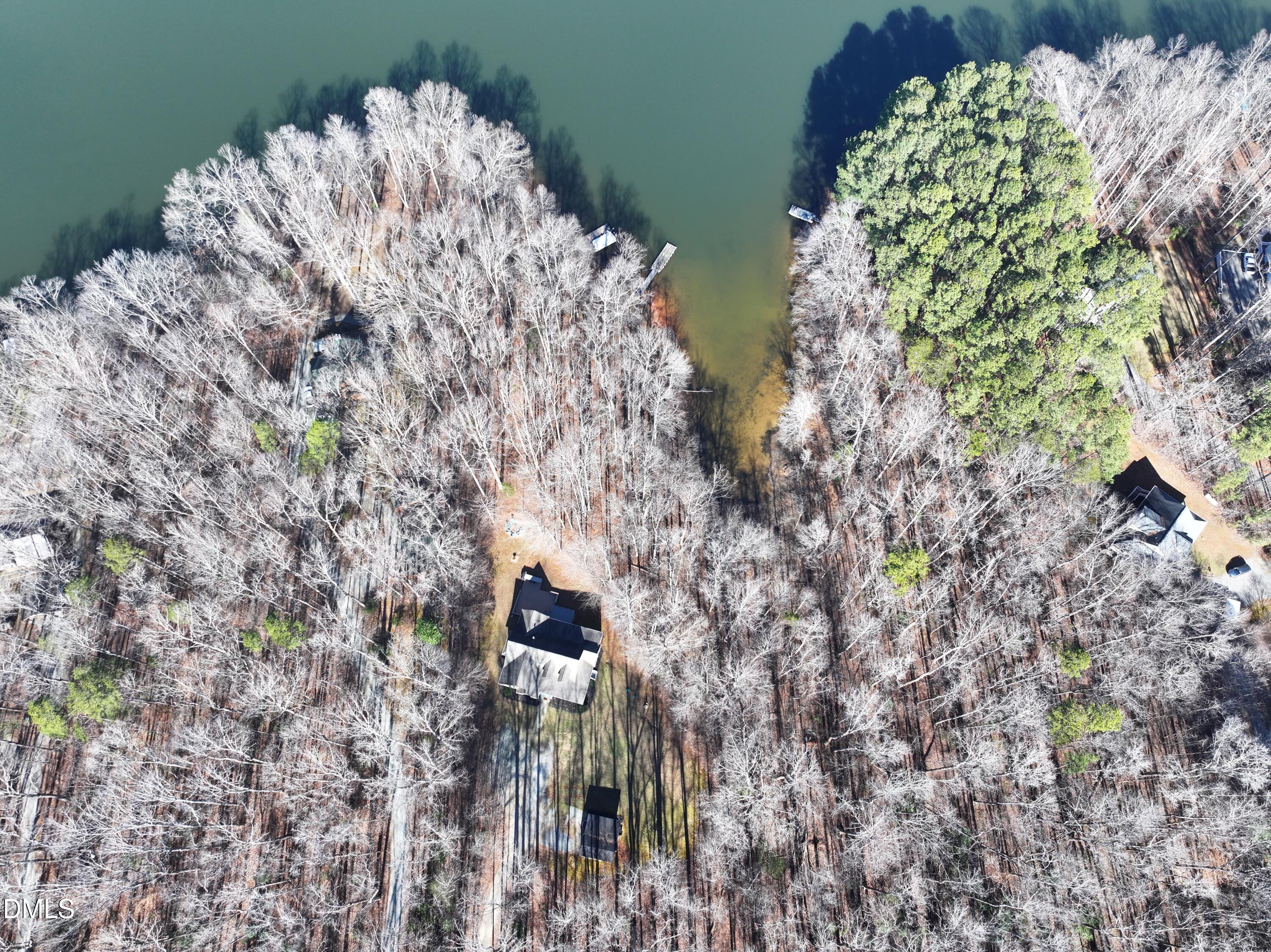 199 Oakwood Lane Roxboro, NC 27574 - Photo 81 of 82 a aerial view of a house with a yard and covered with trees