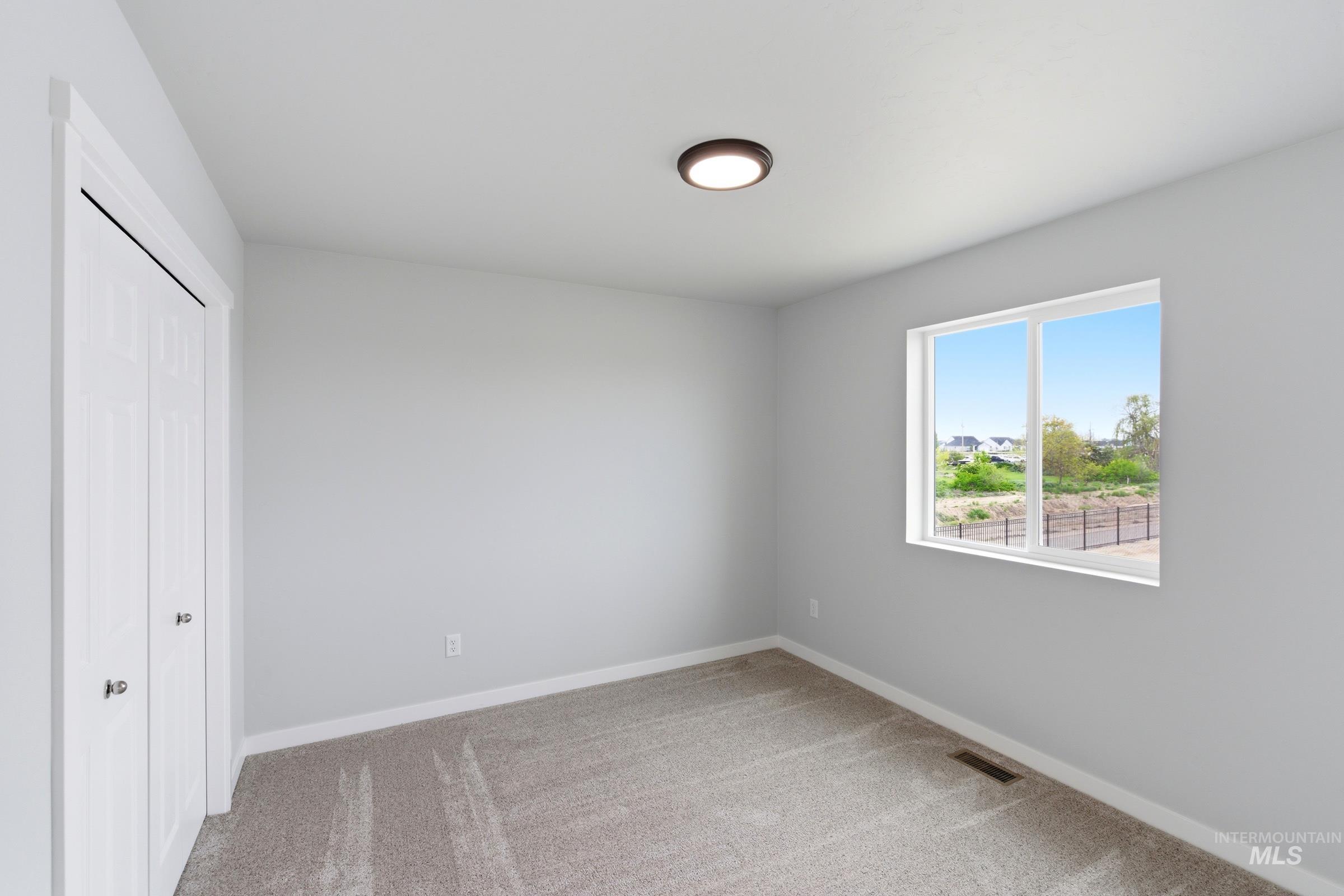 16558 Dunning Way Caldwell, ID 83607 - Photo 22 of 35 Neutral-toned room with light gray walls and plush carpet flooring