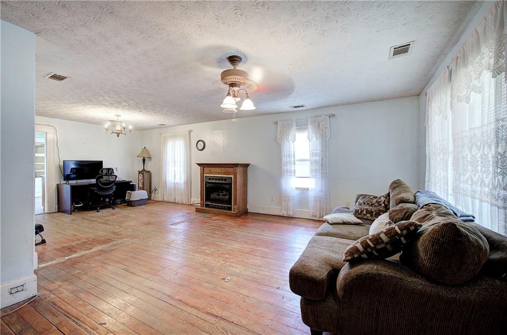 798 Mt Pleasant Road Rydal, GA 30171 - Photo 25 of 31 a living room with furniture and a fireplace