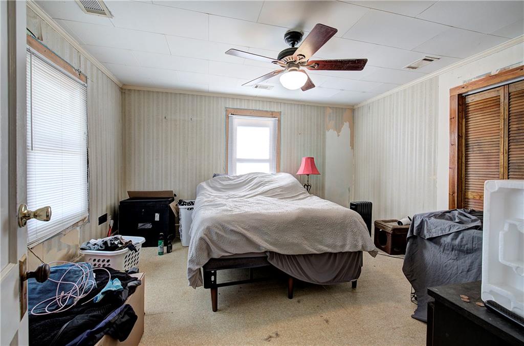 798 Mt Pleasant Road Rydal, GA 30171 - Photo 28 of 31 a bedroom with a bed and a chandelier