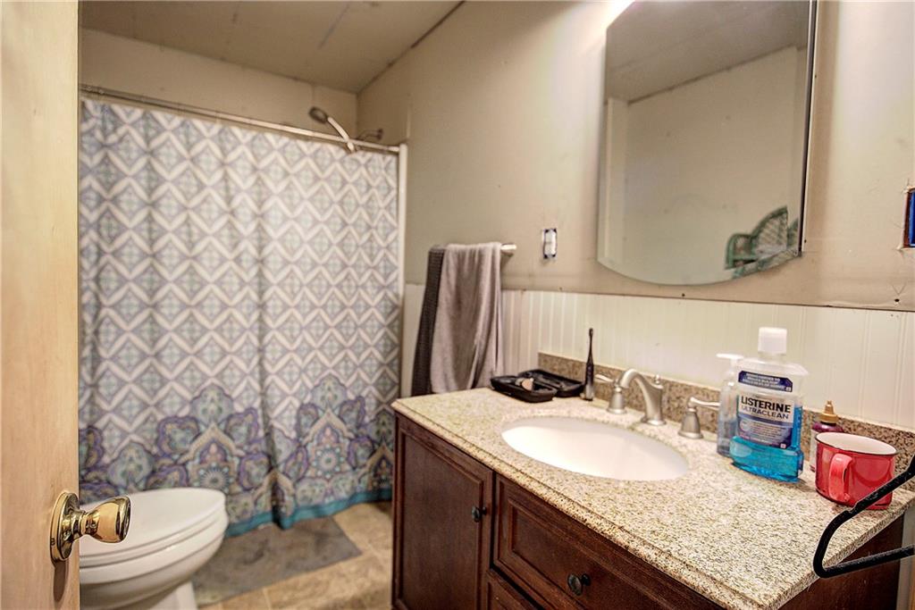 798 Mt Pleasant Road Rydal, GA 30171 - Photo 31 of 31 a bathroom with a granite countertop sink and a mirror