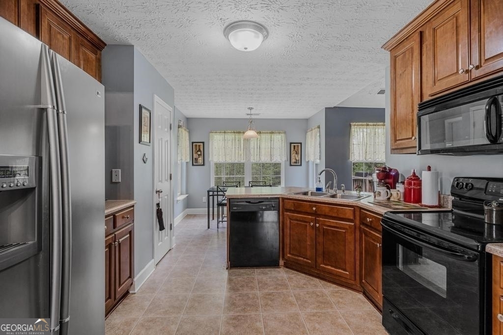 80 Upper Caldwell Road Bowdon, GA 30108 - Photo 8 of 33 a kitchen with cabinets and stainless steel appliances
