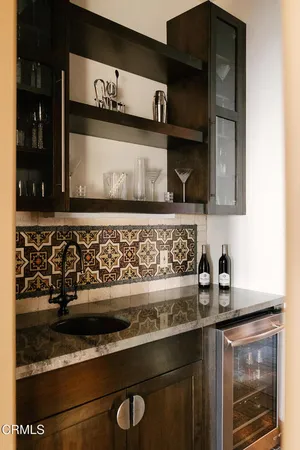 a kitchen with a sink stove top oven and cabinets