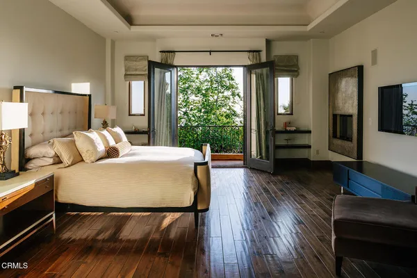 a view of a hallway with wooden floor and windows