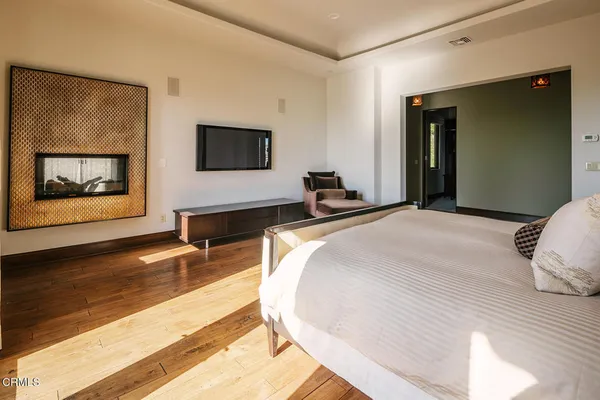 a bedroom with a bed lamp and window