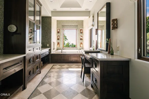 a view of a workspace with furniture and a bathroom
