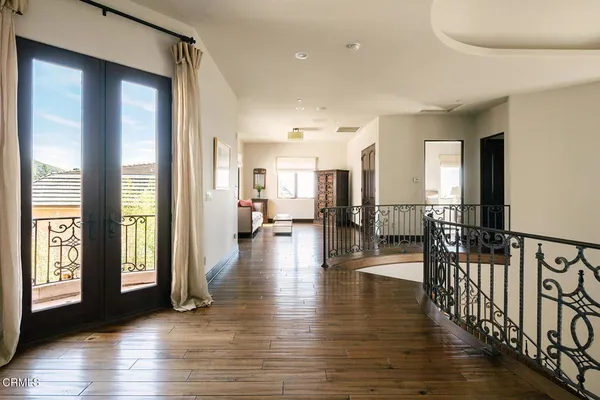 a view of a house with a dining table and chairs in patio