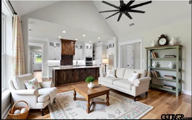 a living room with furniture and a wooden floor