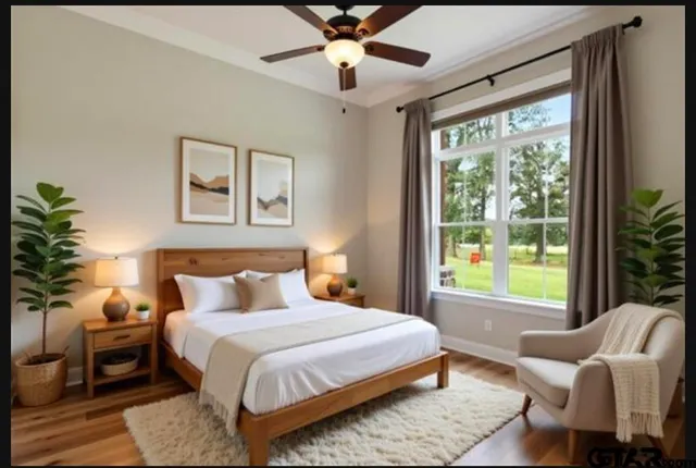 a bedroom with furniture and a large window