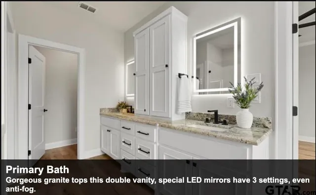 a view of bathroom with sink and mirror