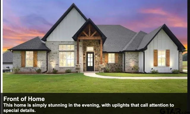 a front view of a house with a big yard