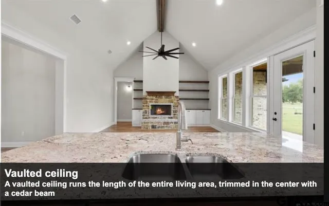 a view of a kitchen with kitchen island a sink and wooden floor