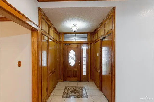 a view of a bathroom with mirror and shower