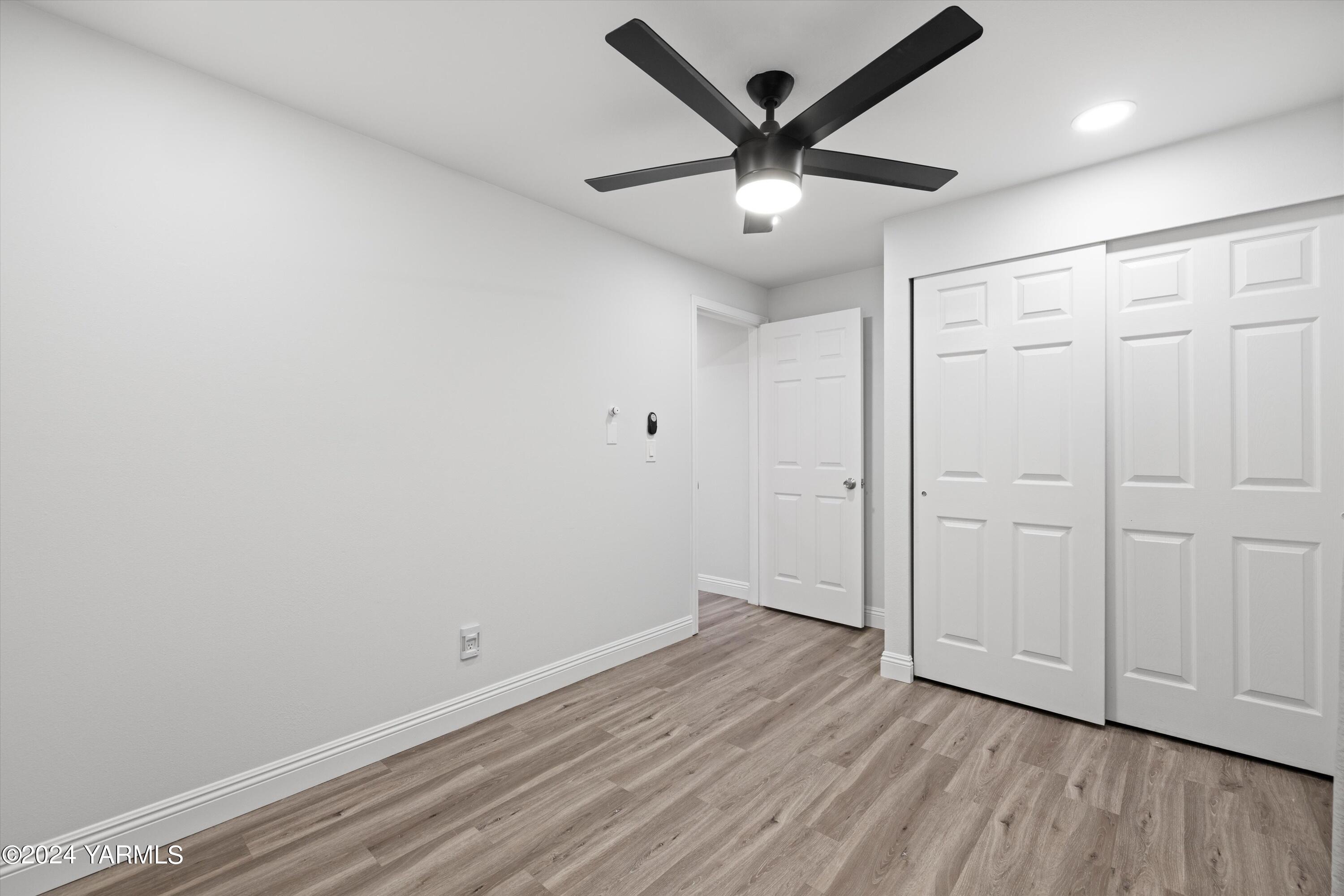 1511 Progressive Road Wapato, WA 98951 - Photo 13 of 36 an empty room with wooden floor and windows