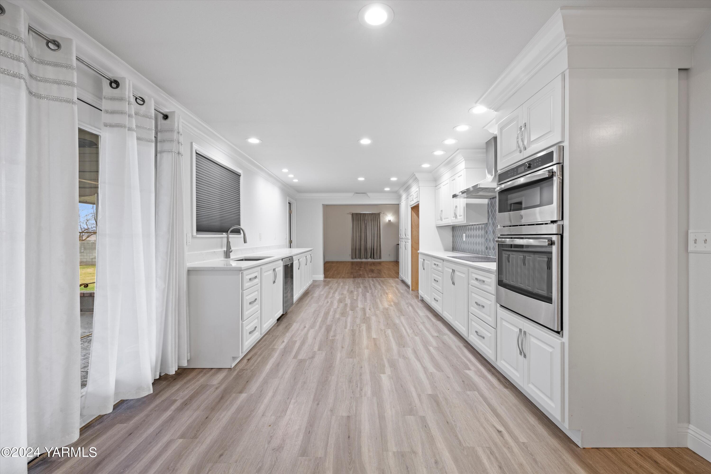 1511 Progressive Road Wapato, WA 98951 - Photo 22 of 36 a view of a kitchen center island wooden floor and stainless steel appliances