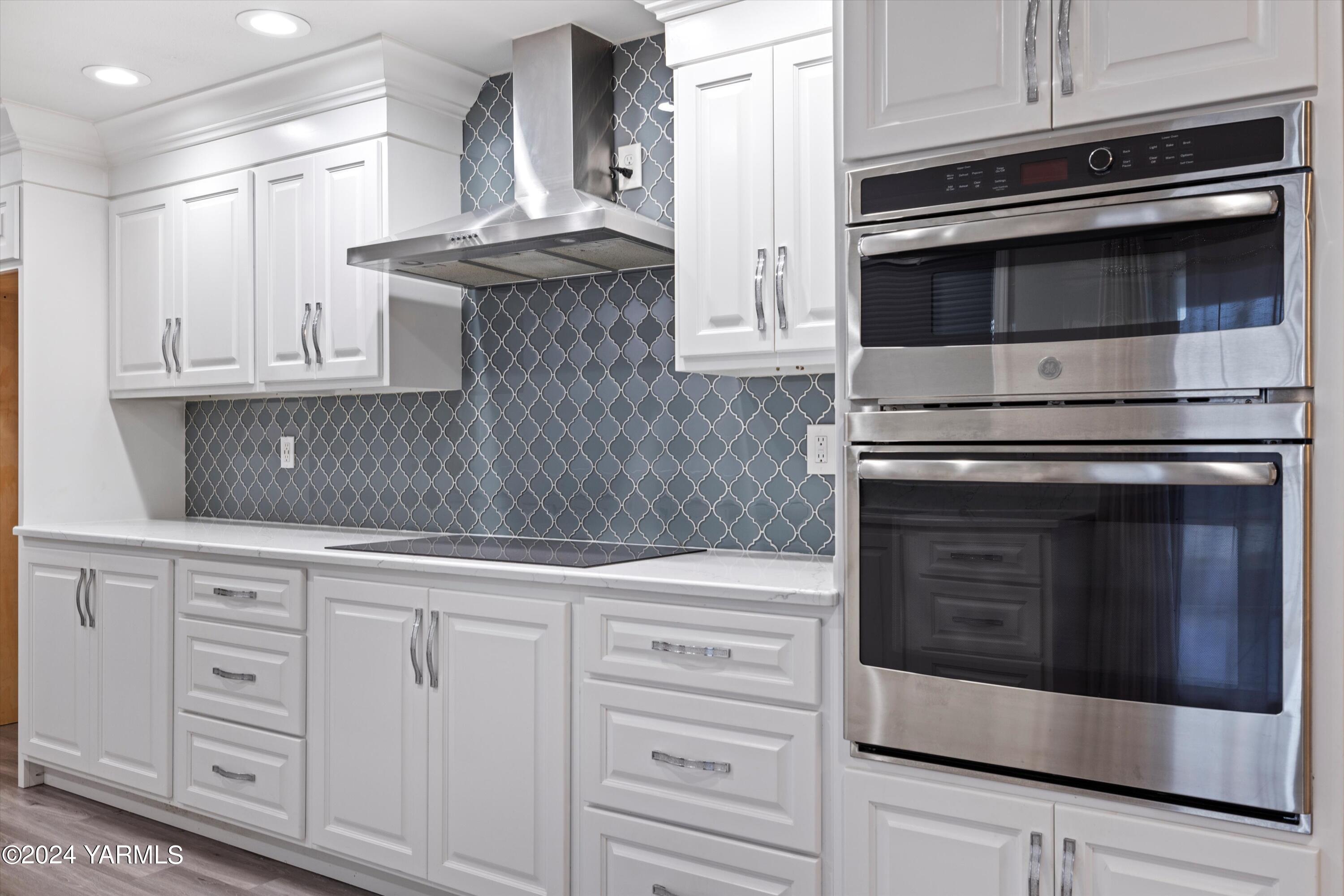 1511 Progressive Road Wapato, WA 98951 - Photo 23 of 36 a kitchen with granite countertop white cabinets and stainless steel appliances