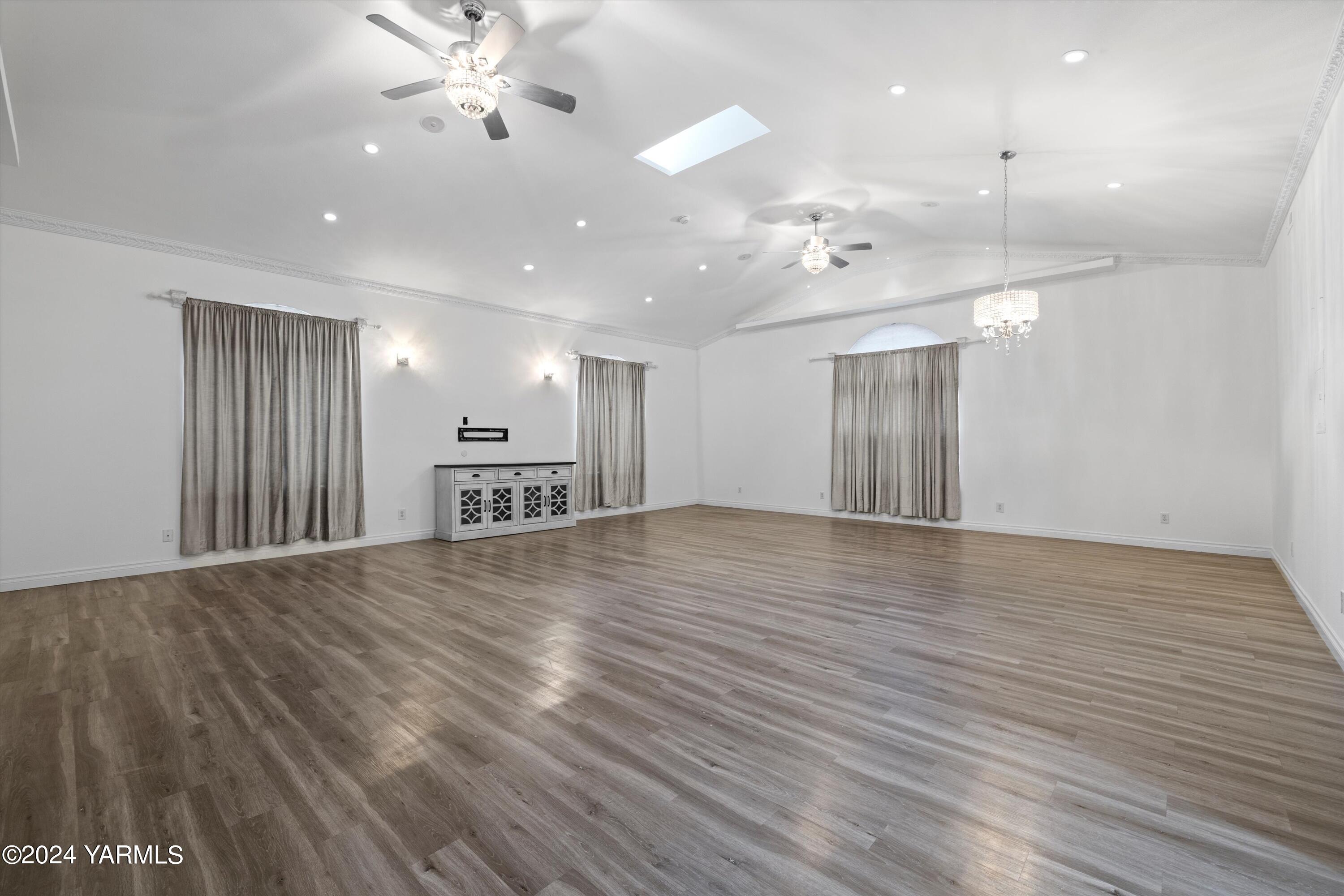 1511 Progressive Road Wapato, WA 98951 - Photo 26 of 36 a view of an empty room with wooden floor and a ceiling fan
