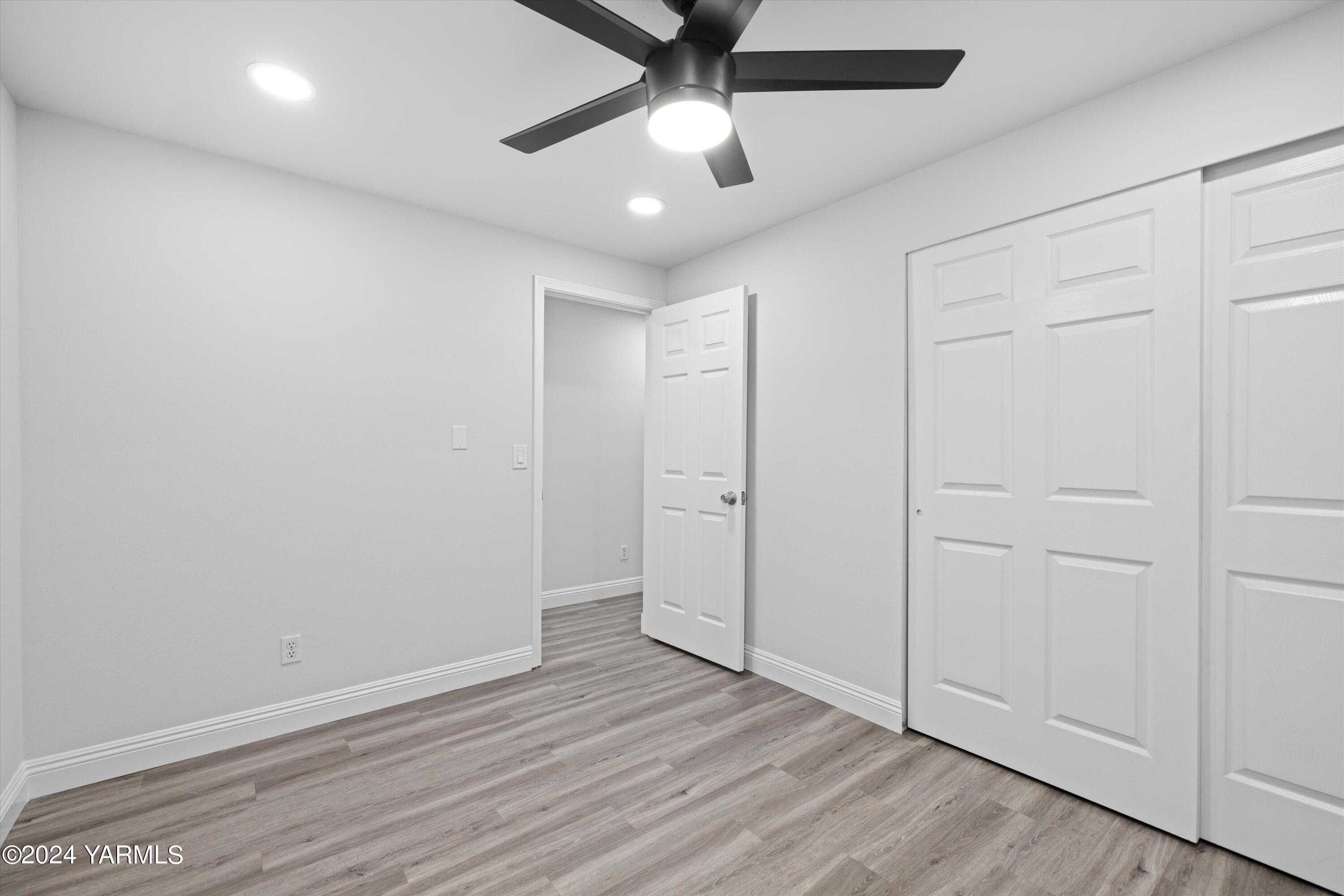1511 Progressive Road Wapato, WA 98951 - Photo 9 of 36 an empty room with wooden floor and ceiling fan