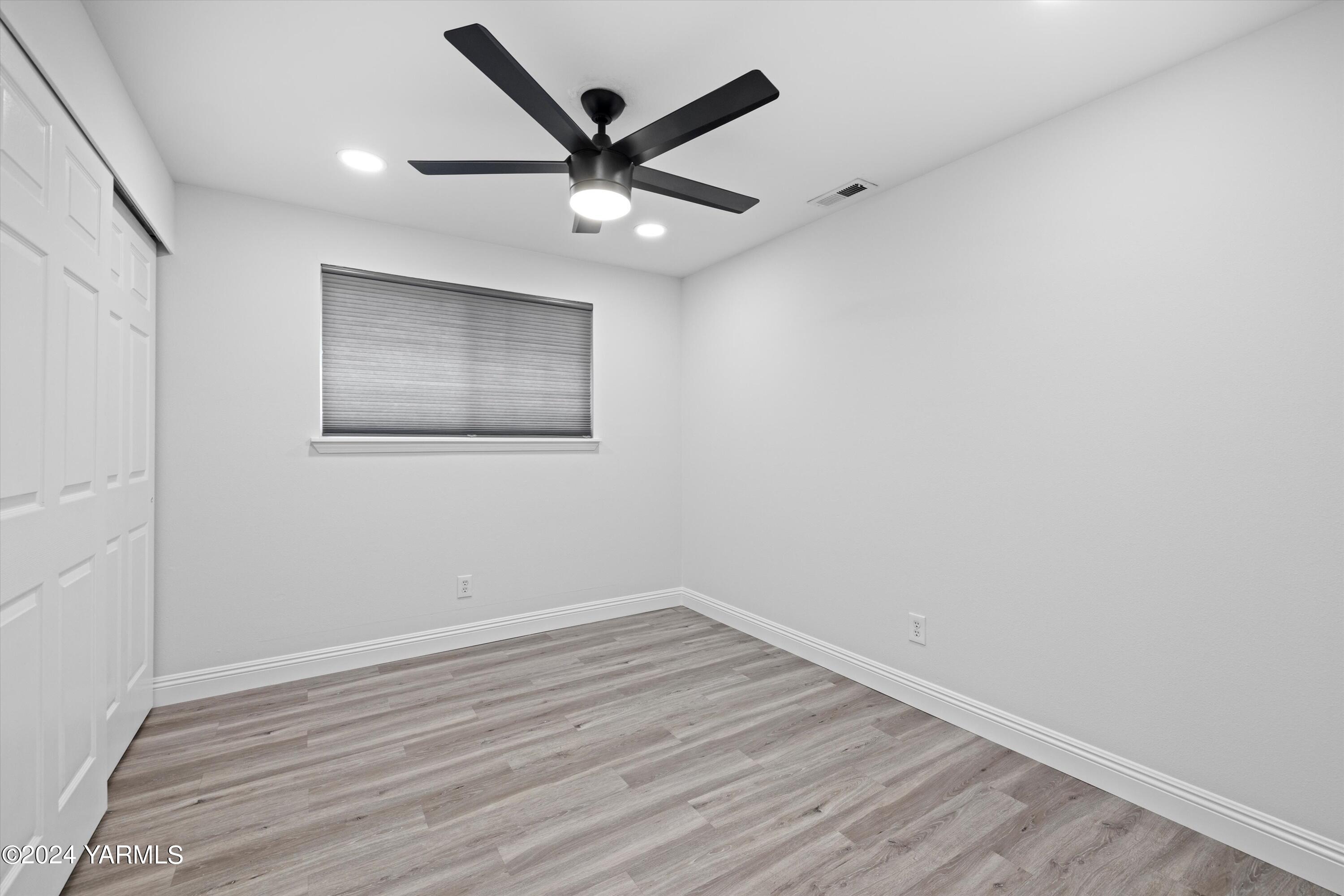 1511 Progressive Road Wapato, WA 98951 - Photo 10 of 36 an empty room with wooden floor and windows