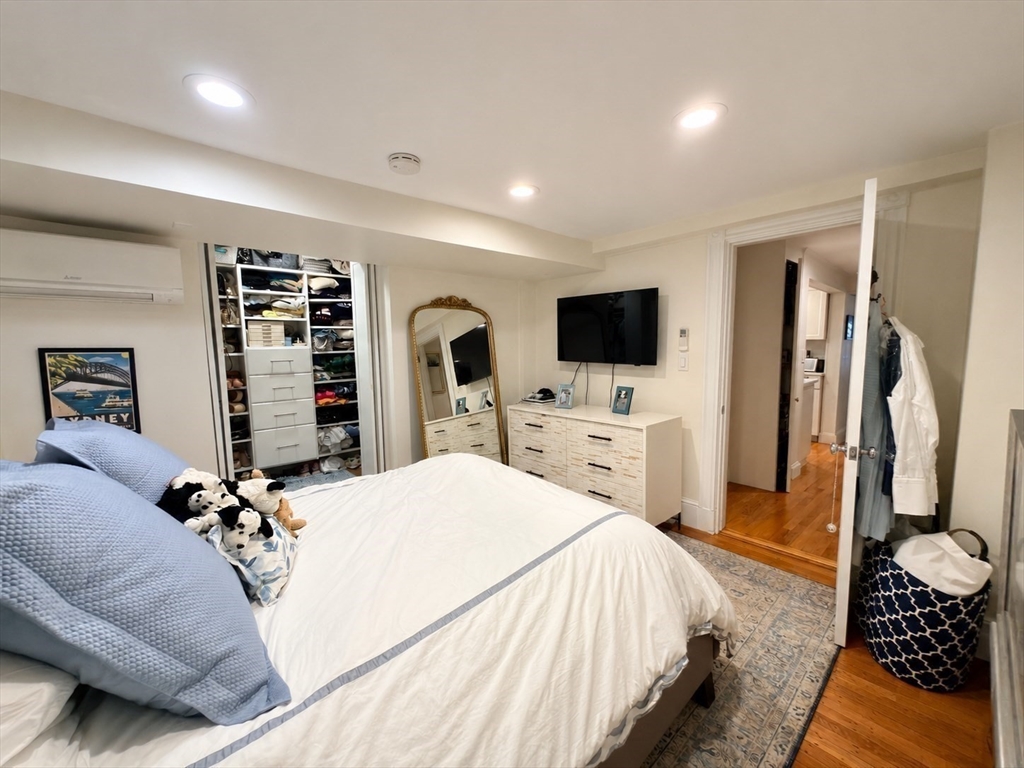 41 Pinckney Street, Unit B Boston, MA 02114 - Photo 12 of 31 a bedroom with a large bed and a flat screen tv