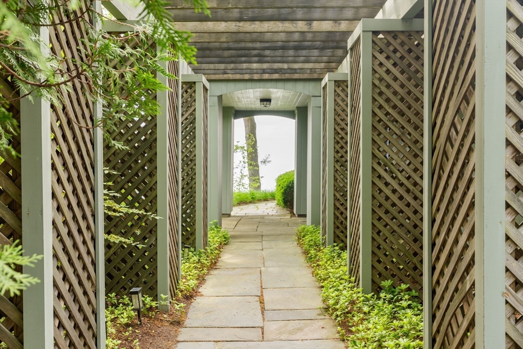 23 Ocean Street Manchester, MA 01944 - Photo 5 of 36 a view of a pathway both side of the house