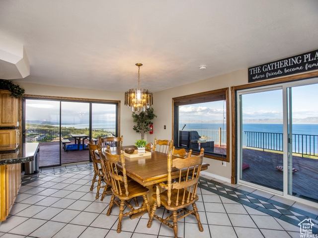 588 Raspberry Patch Road Garden City, UT 84028 - Photo 19 of 74 Dining space featuring a water view, plenty of natural light, and light tile patterned floors