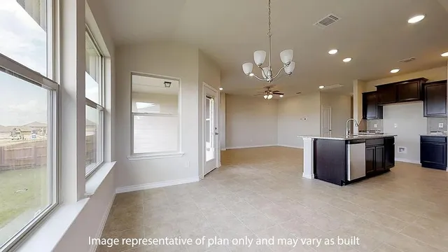 a view of a kitchen with a sink and a large window
