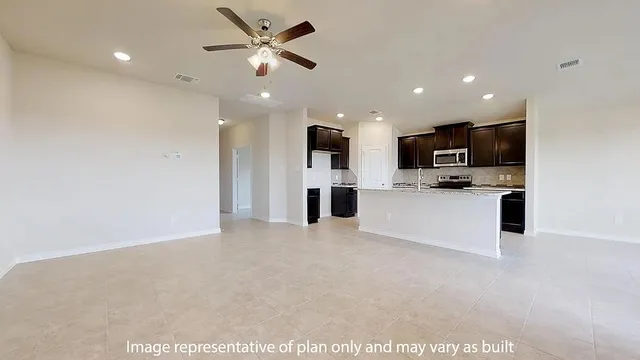 a view of kitchen with microwave and refrigerator