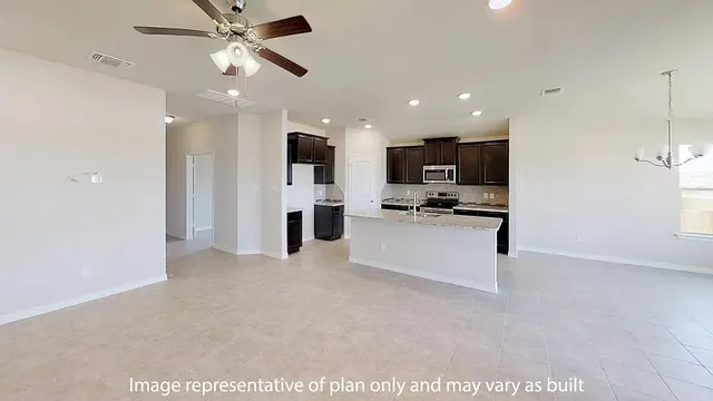 a view of kitchen with kitchen island stainless steel appliances refrigerator stove microwave and cabinets