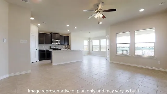 a large kitchen with stainless steel appliances kitchen island granite countertop a stove a sink a refrigerator and a granite counter top