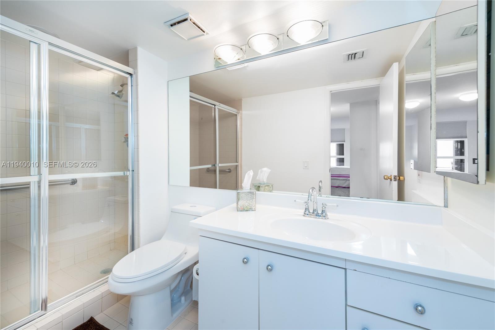 4000 Towerside Terrace, Unit 805 Miami, FL 33138 - Photo 15 of 18 a bathroom with a sink a toilet and shower