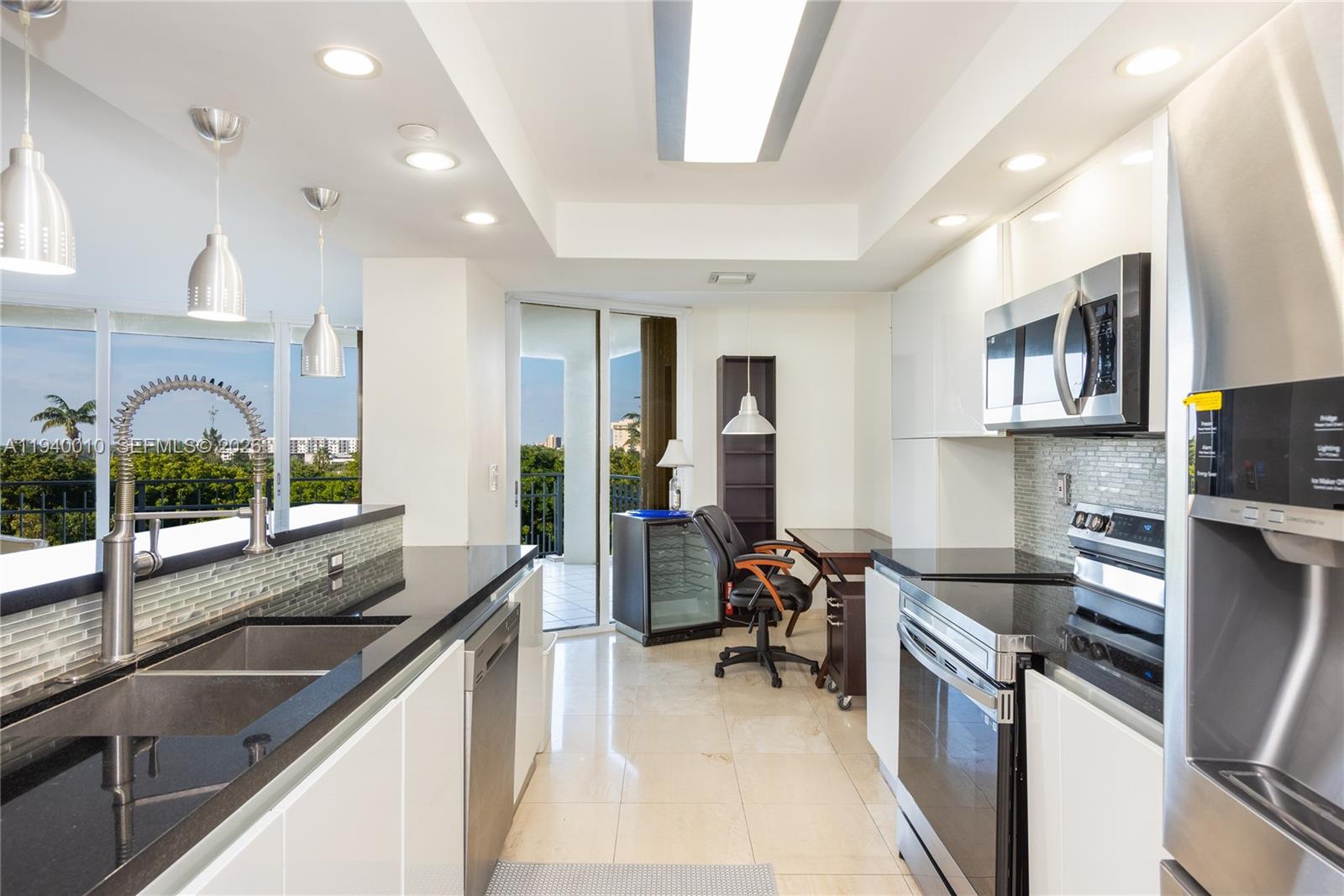4000 Towerside Terrace, Unit 805 Miami, FL 33138 - Photo 6 of 18 a kitchen with sink refrigerator and stove