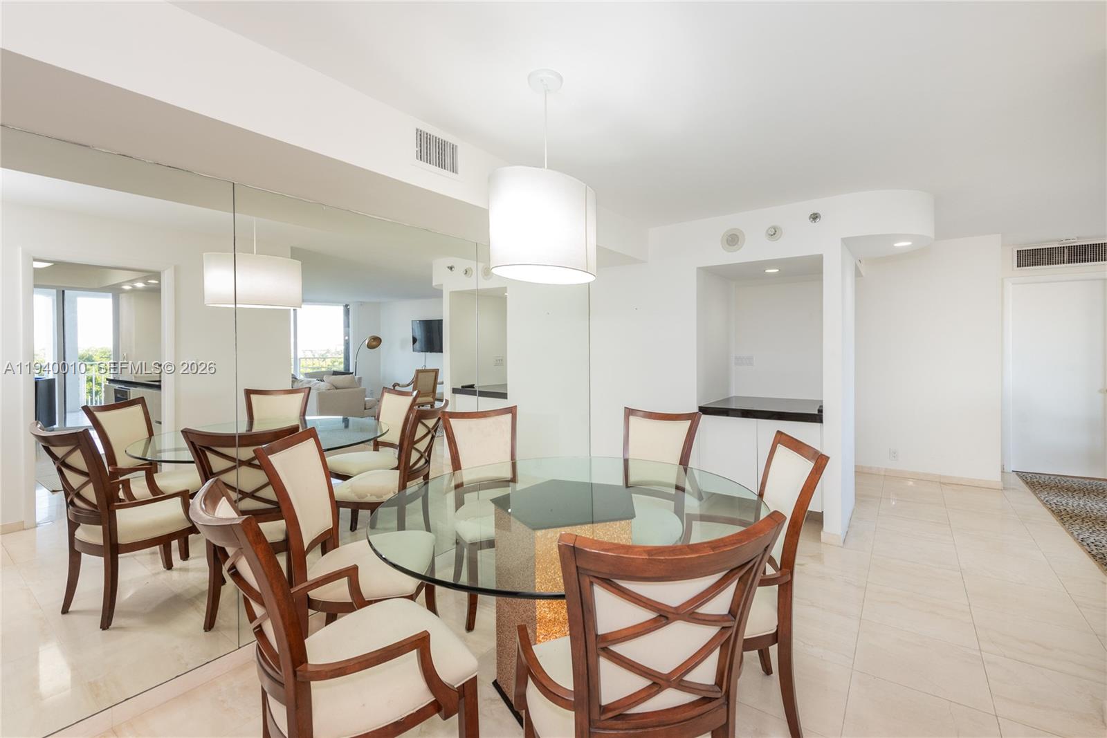 4000 Towerside Terrace, Unit 805 Miami, FL 33138 - Photo 9 of 18 a dining room with furniture and a mirror