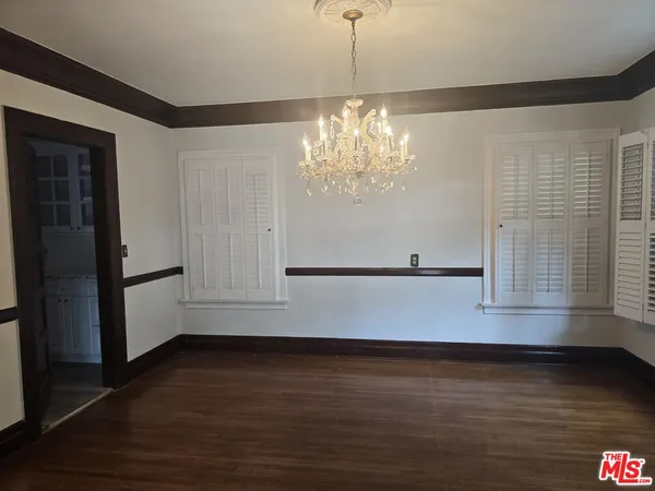 a view of wooden floor and windows in a room