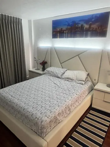 a bed sitting in a bedroom and balcony